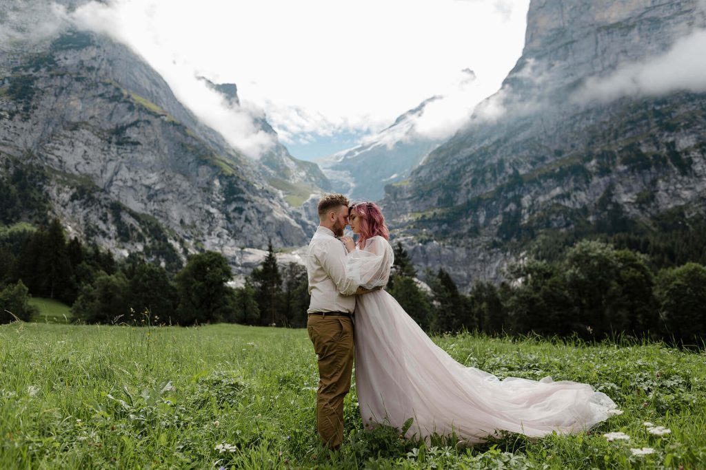 happy-bride-and-groom-hugging-on-green-mountain